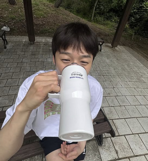 jung joon-won resident playbookMan-Drinking-Mug-Outdoors.