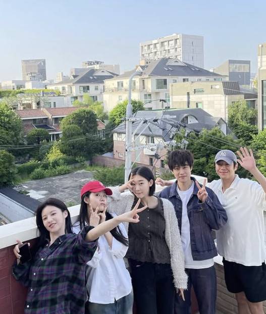jung joon-won resident playbookgroup-rooftop-peace-signs-cityscape.