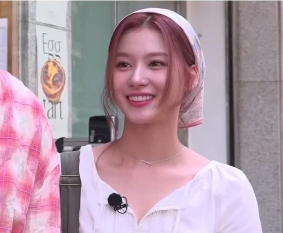 twice sana debut storywoman-smiling-scarf-whiteblouse.