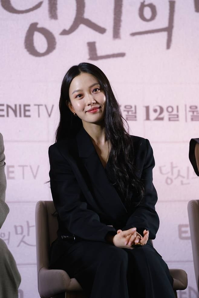 tastefully yours go min-si accentwoman-blackSuit-smiling-indoor.