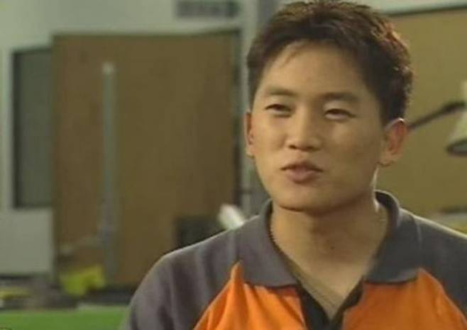 Ji Sung success storyman-asian-orange-shirt-indoors.