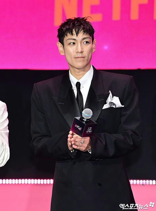 t.o.p squid game 3 comebackman-suit-microphone-pinkbackground.