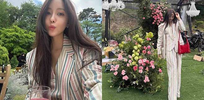 K-pop stars wedding guest visualswoman-stripedSuit-flowers-outdoors.