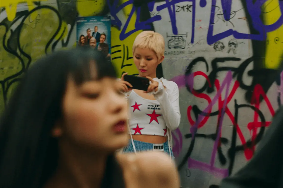 baby dont cry visualsAsian-woman-phone-graffiti-wall.