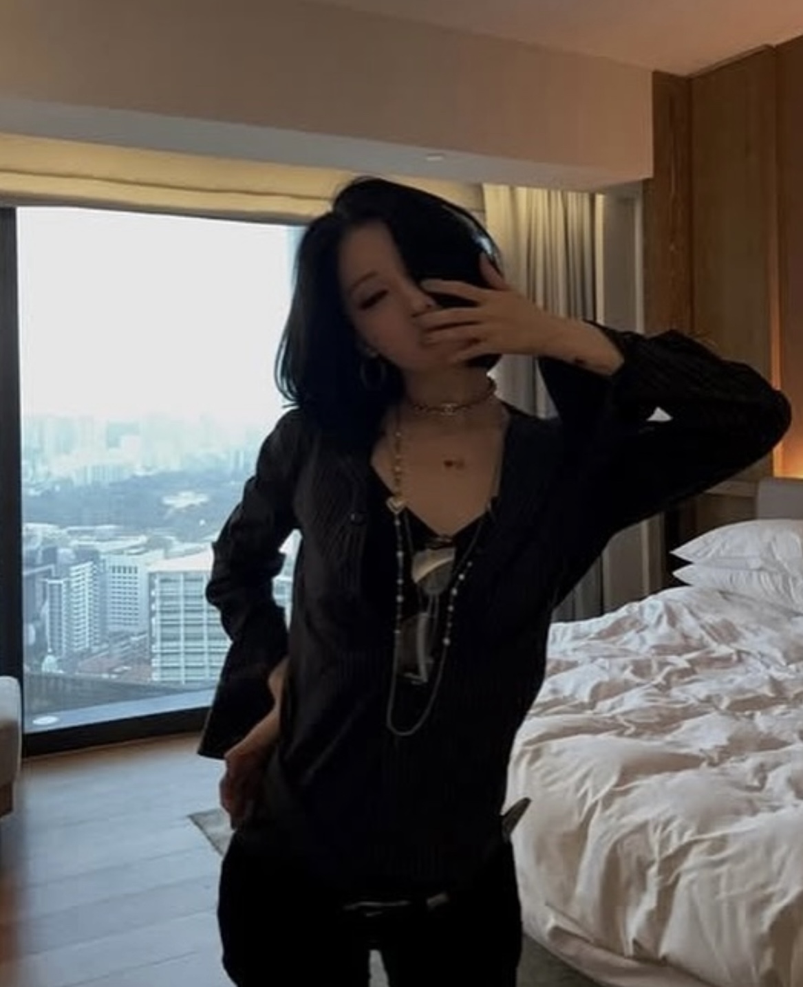 babymonster asa fashion vibewoman-bedroom-blackclothing-cityview.