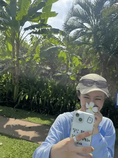 resident playbook bali reward vacationwoman-flower-phone-tropical.