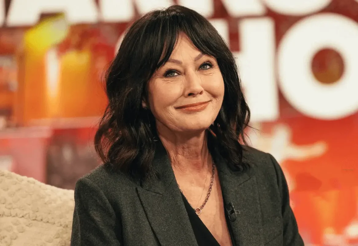 Shannen Doherty death anniversarywoman' 'brunette' 'jacket' 'smiling.