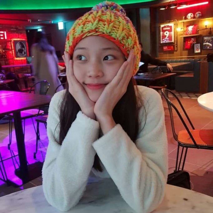 Youngseo pre-debut visualswoman-beanie-restaurant-smiling.